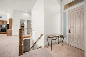 Foyer featuring light tile patterned floors and recessed lighting