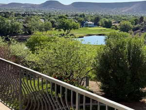 Balcony with a water and mountain view