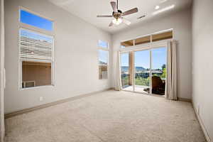 Spare room with ceiling fan and light carpet