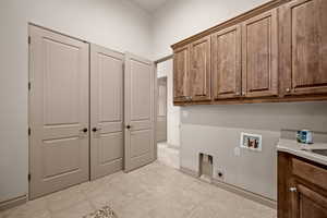 Laundry room with cabinet space, washer hookup, and electric dryer hookup