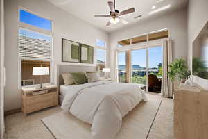 Bedroom with access to exterior, light colored carpet, and a ceiling fan