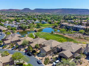 Aerial view of residential area featuring a water and mountain view and a golf course