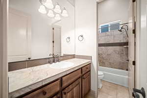 Bathroom with vanity, shower / washtub combination, and light tile patterned flooring