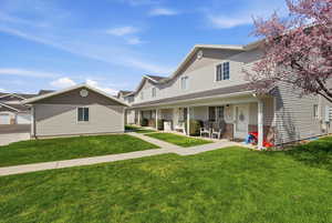 View of front facade with a porch and a front lawn