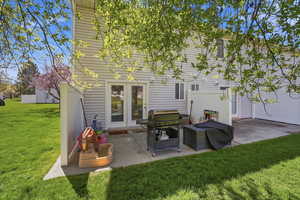 Back of house featuring a patio area and a yard