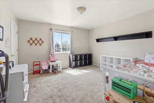 Bedroom with light carpet and baseboards