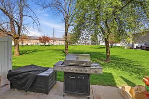View of patio featuring a grill and a residential view