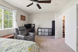 Bedroom featuring light colored carpet and a ceiling fan