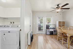 Dining area featuring ceiling fan, light wood finished floors, heating unit, and independent washer and dryer