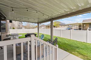 Fenced backyard with a residential view, a patio area, and grilling area