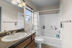 Full bath with vanity and shower / tub combo with curtain