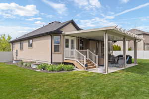 Rear view of property with a patio and stucco siding