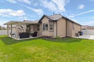 Rear view of property with a fenced backyard, a patio area, stucco siding, and a pergola