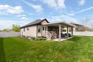 Rear view of house with a fenced backyard, a patio area, and a gate