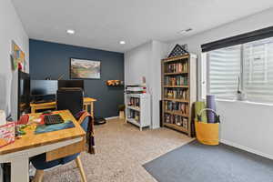 Office space with light colored carpet, recessed lighting, and a textured ceiling