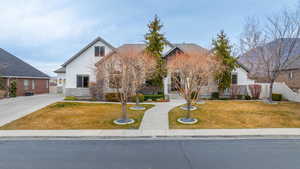 View of front of house with stone siding and stucco siding