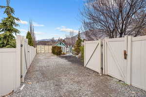 View of yard with a gate and a mountain view
