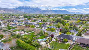 Aerial perspective of suburban area with mountains and a pool