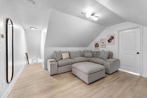 Living area featuring light wood finished floors and baseboards