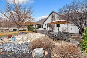 Back of property with a patio area and outdoor dining space