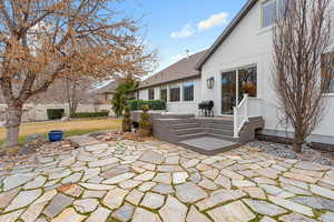 View of patio with area for grilling and a deck