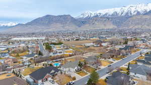 Aerial overview of property's location with a mountainous background and nearby suburban area