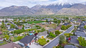 Aerial view of residential area featuring a mountainous background