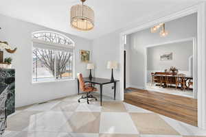 Office with suspended lighting and baseboards