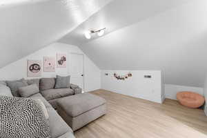 Living room featuring light wood-style flooring and a textured ceiling