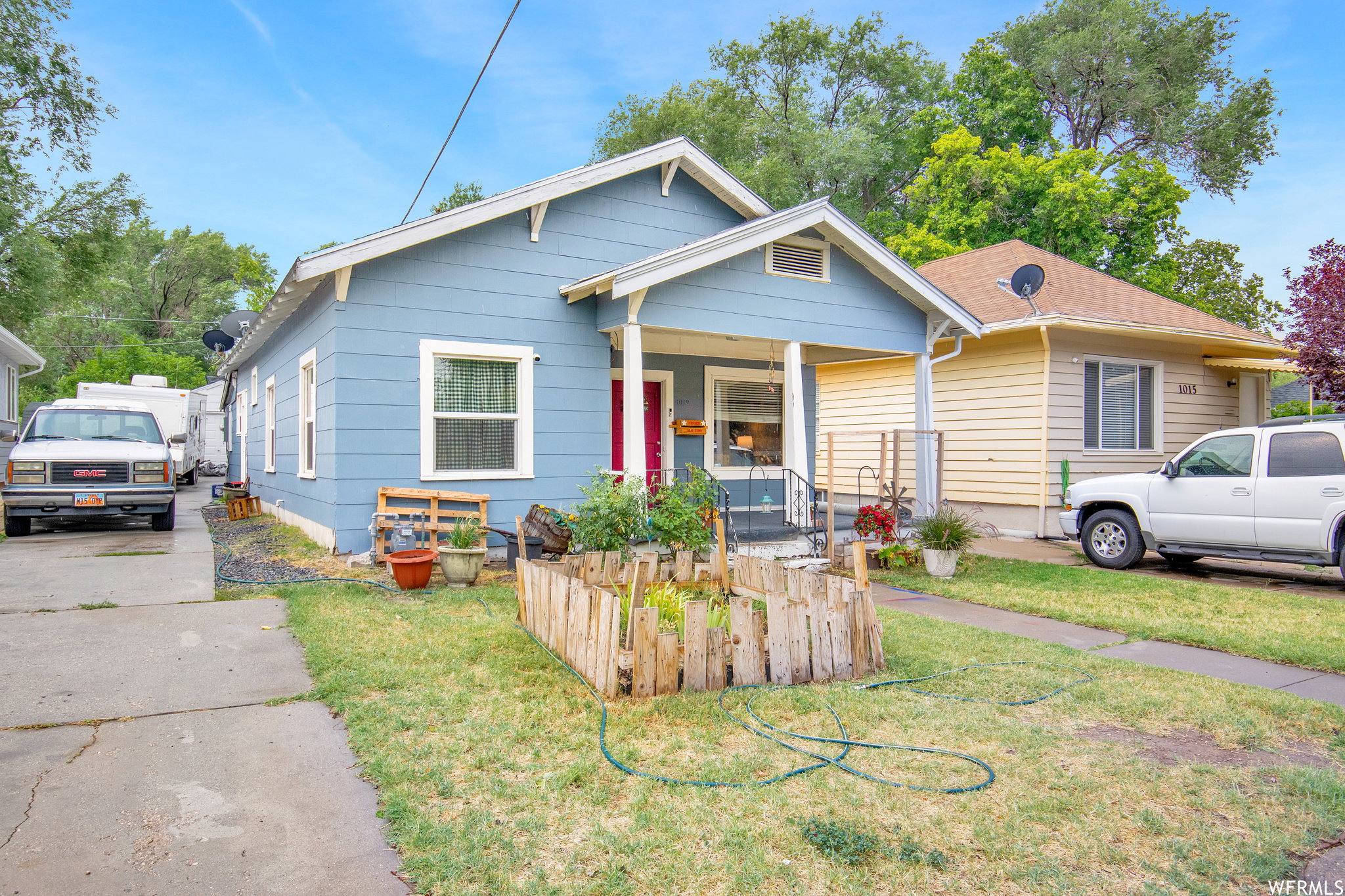 Bungalow-style home with a front lawn and covered porch