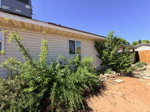 View of side of home featuring a cooling unit