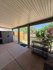 Fenced backyard with a storage shed and a patio area