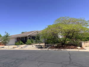 View of front of home featuring a garage and a tiled roof