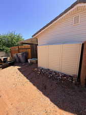 View of side of home featuring a fenced backyard