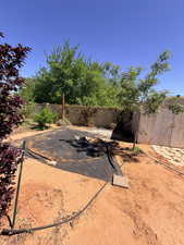 Fenced backyard with a storage shed