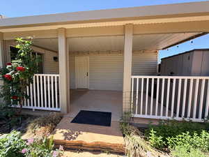 Entrance to property featuring covered porch