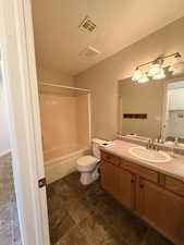 Full bath featuring vanity, shower / bathtub combination, and a textured ceiling