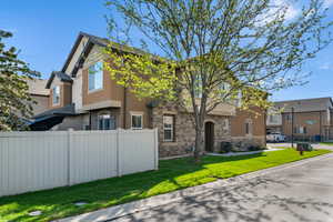 Traditional home featuring stone siding and stucco siding
