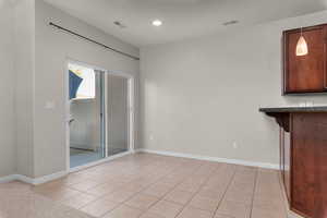 Unfurnished dining area featuring light tile patterned floors and recessed lighting