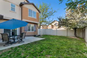 Fenced backyard featuring a gate, a patio area, and outdoor dining area