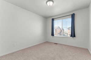 Spare room with baseboards and carpet flooring