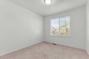 Empty room with baseboards and carpet