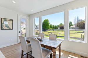 Dining area featuring light wood finished floors and recessed lighting