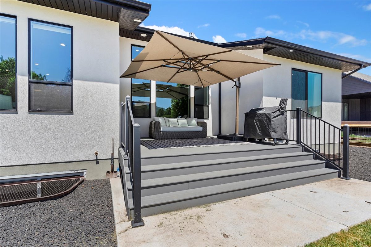 Deck with outdoor furniture, a patio, and a grill