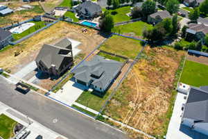 Aerial perspective of suburban area featuring property boundaries highlighted