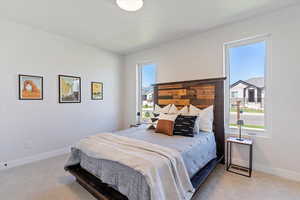 Bedroom featuring light carpet