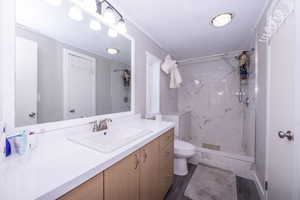 Bathroom featuring vanity and a marble finish shower