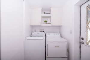 Laundry area with cabinet space and washer and dryer