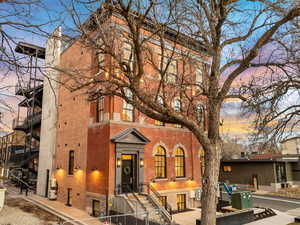View of front facade featuring a gate, brick siding, and a fenced front yard