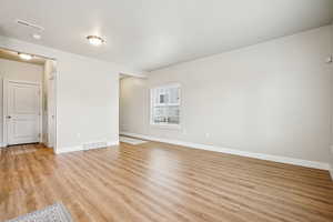 Unfurnished room featuring light wood-type flooring and baseboards